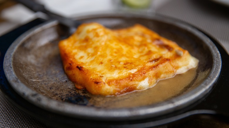 Flaming saganaki on black skillet