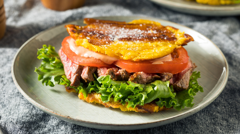 Jibarito with lettuce and tomato on grey plate
