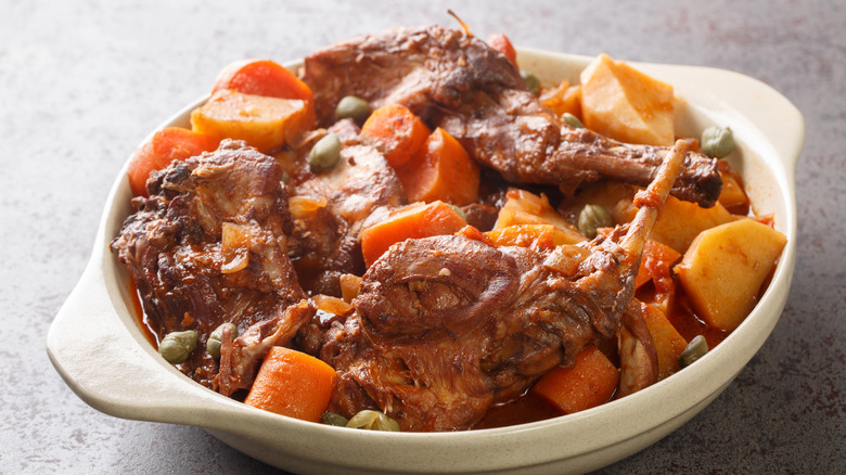 close up of rabbit stew in white dish