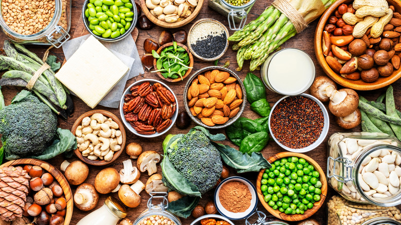 Table full of healthy foods, including nuts, edamame, beans, and vegetables