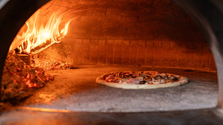 thin-crust pizza in a traditional wood-fired brick oven