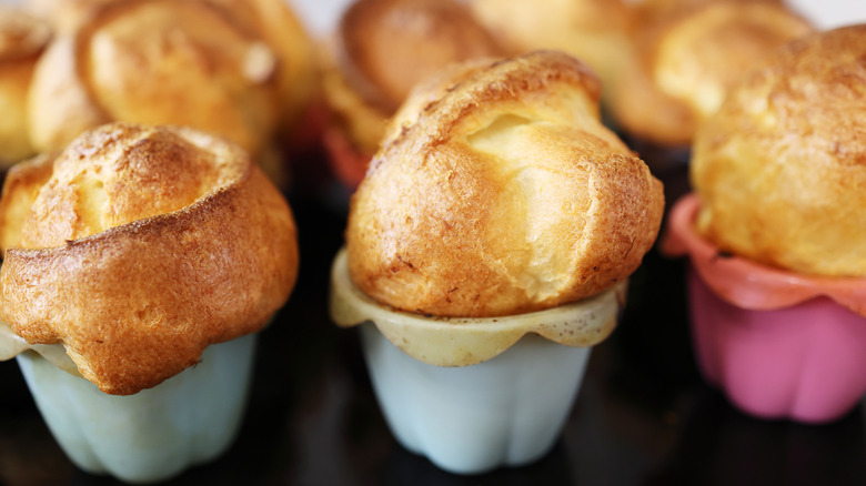 popovers baked in colorful silicone cups, shown fresh from the oven before they deflate