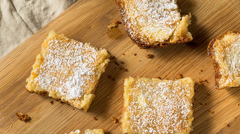 Gooey butter cake slices on a wooden board