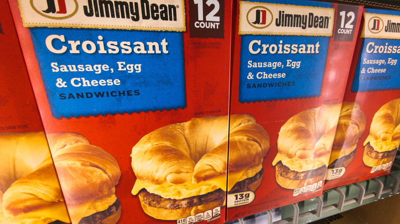 freezer case display of Jimmy Dean brand breakfast sandwiches, with sausage, egg and cheese on a croissant