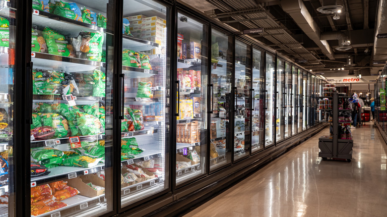 Long shot of the frozen foods aisle of a supermarket