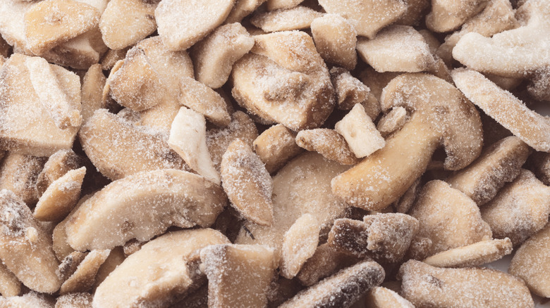 closeup image of sliced, frozen button mushrooms
