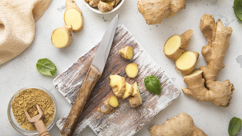 Fresh and powdered ginger, cutting board, and knife