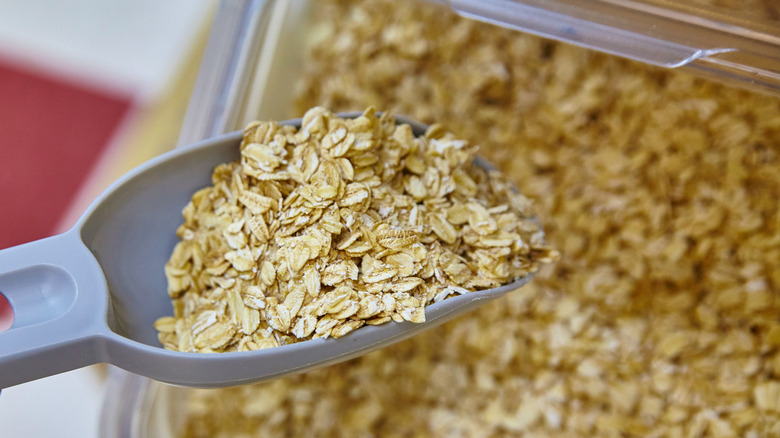 scooping oats out of a container