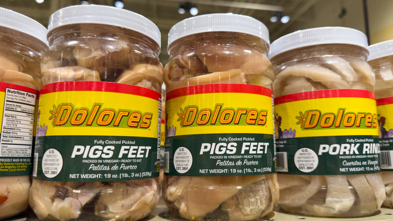 Jars of pickled pig's feet on a grocery store shelf
