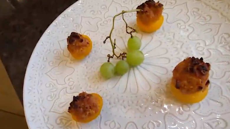 Four Spam fiesta peach cups on a plate with grapes