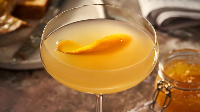 Breakfast martini close-up with orange marmalade in background.