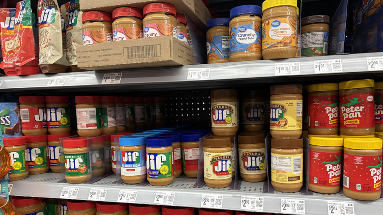 Three brands of peanut butter on Walmart shelves
