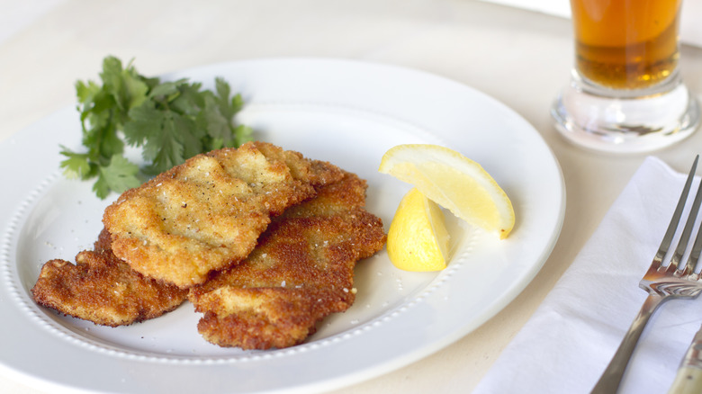 Weiner schnitzel steak on a white plate with salad