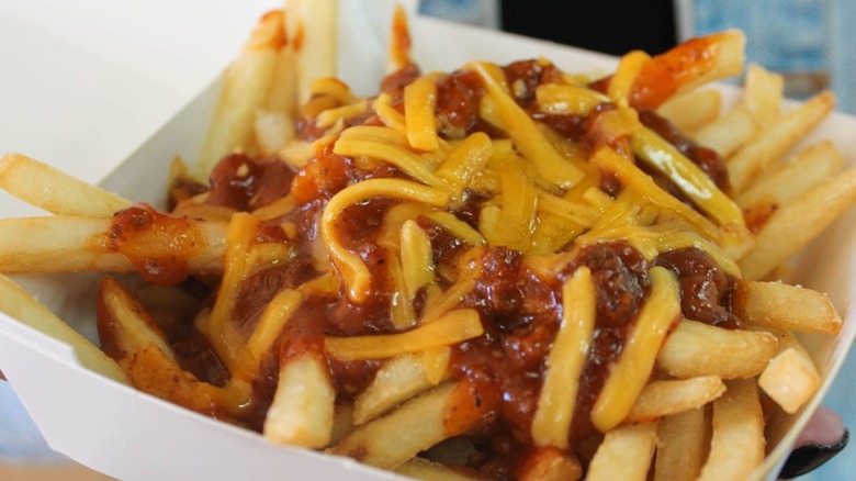Wienerschnitzel chili cheese fries in white takeout container
