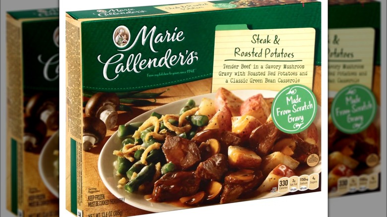 Green and beige box of frozen Marie Callender's Steak and Roasted Potatoes, with plate of meat veggies and potatoes on the cover