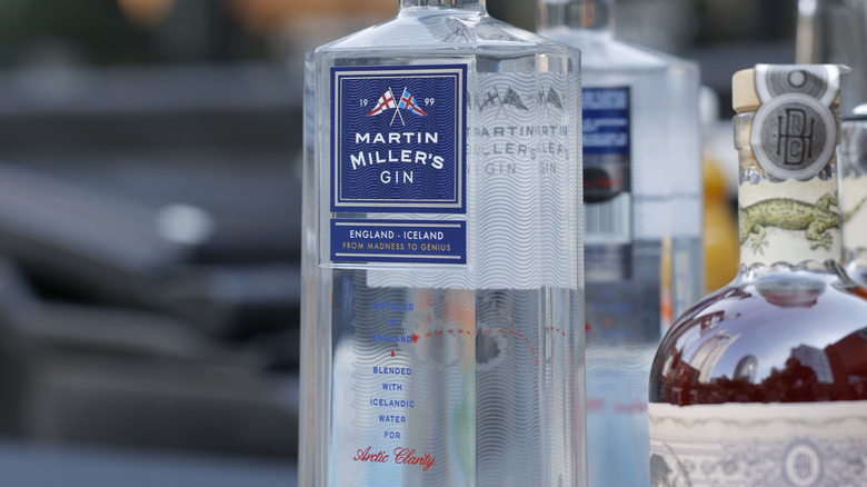 Close up of Martin Miller's Gin bottle next to other spirits.