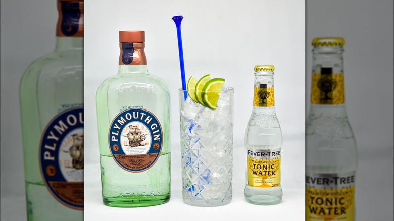 Bottle of Plymouth Gin next to highball glass and bottle of Fever-Tree tonic water