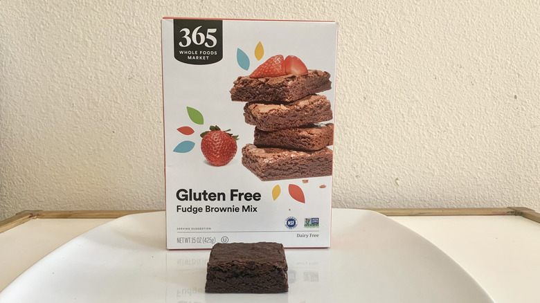 365 Whole Foods Market Gluten Free Fudge Brownie Mix box alongside a baked brownie
