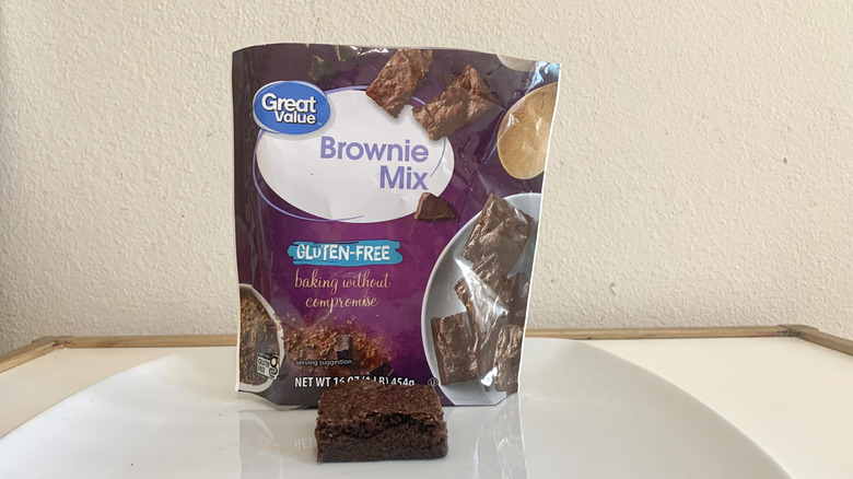 Great Value Gluten-Free Brownie Mix box alongside a baked brownie