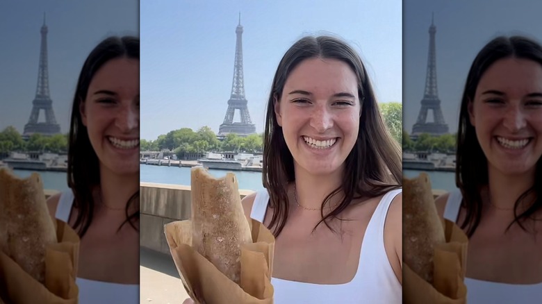 girl eating a gluten free baguette in Paris