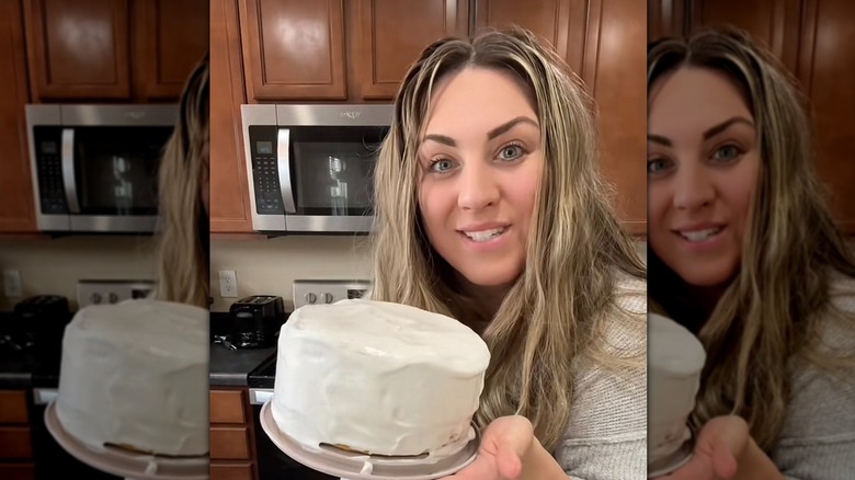 holding up a gluten-free cake