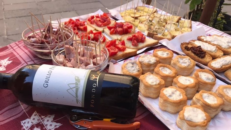 bottle of wine on a table with appetizers