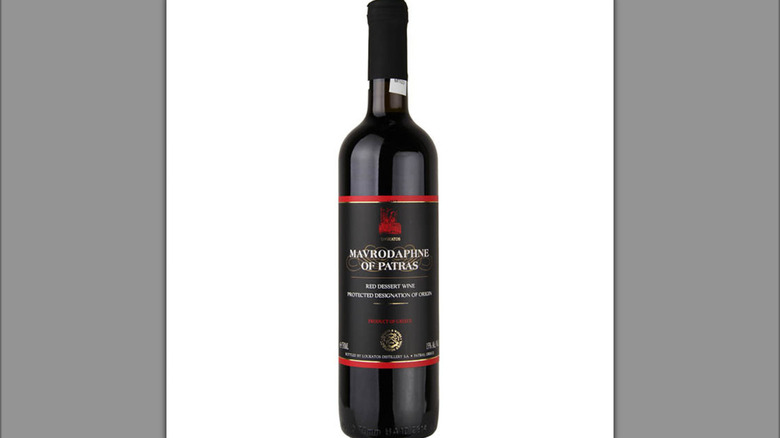 mirror image of a bottle of sweet red Greek wine Mavrodaphne against a white background