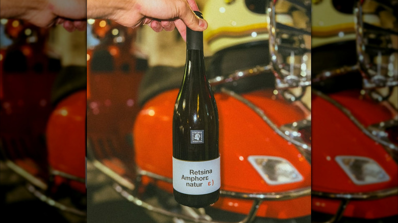 hand holding bottle of Greek retsina wine