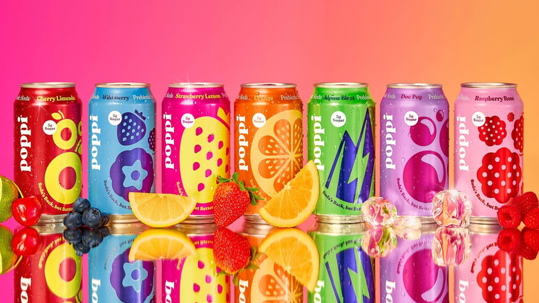 A stylized photo of Poppi cans, feturing several different fruit flavors, with a colourful background.