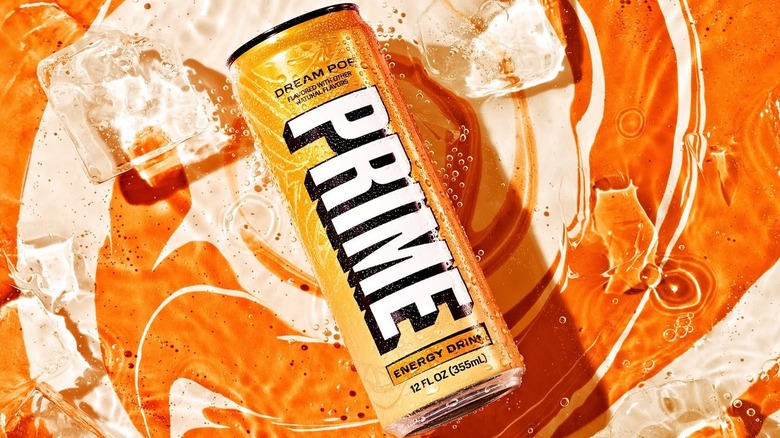 A stylized photo of a can of Prime Energy Drink in Dream Pop against an orange background with ice cubes surrounding it.