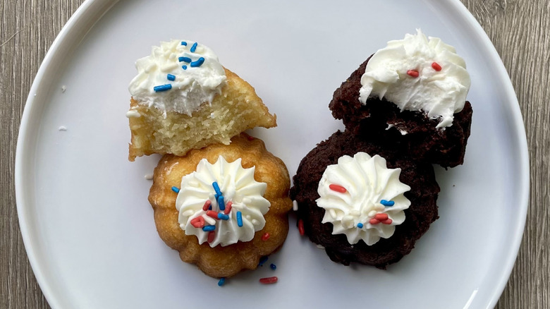 Whole and sliced vanilla and chocolate Bundt cakes on a plate
