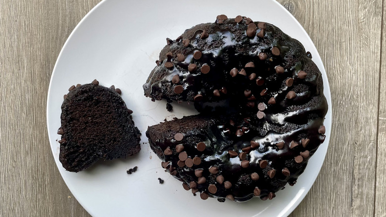 Chocolate Bundt cake with a slice pulled out on a plate