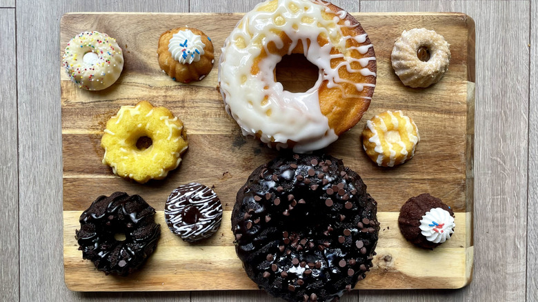 A collection of ten Bundt cakes on a cutting board