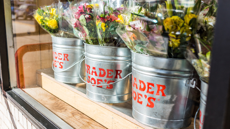 Silver buckets with flowers and Trader Joe's logo