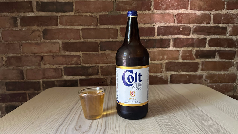 Colt 45 beer in small glass on table