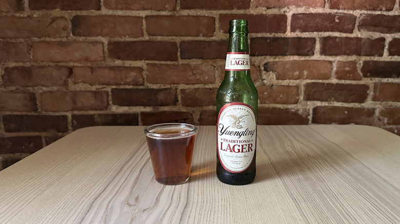 Yuengling beer in small glass on wooden table