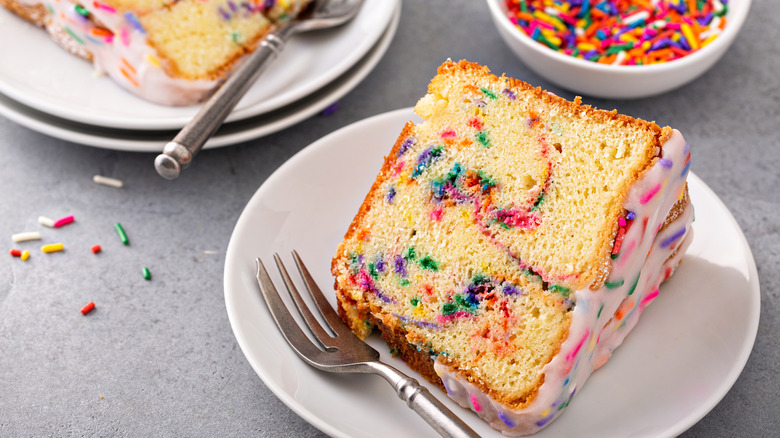 A slice of Funfetti cake with a side of sprinkles