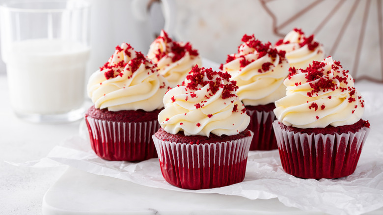Red velvet frosted cupcake on a white background