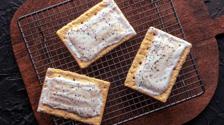 Three frosted pop tarts on a wire baking rack