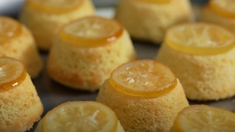 Close up of mini lemon cakes topped with lemon slices