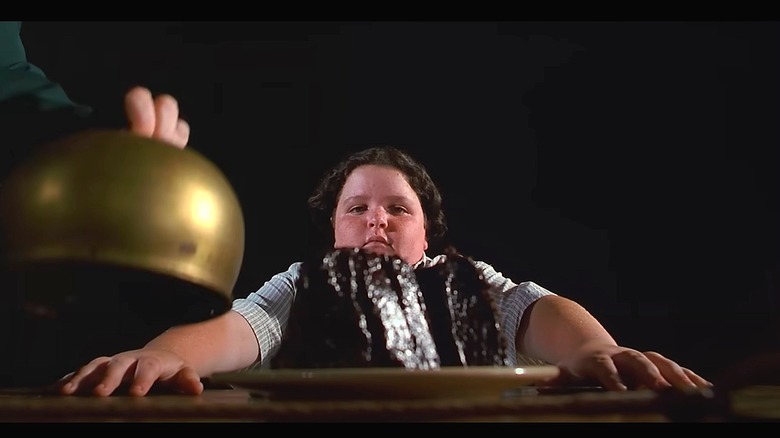 Close up of frosted chocolate cake on white plate