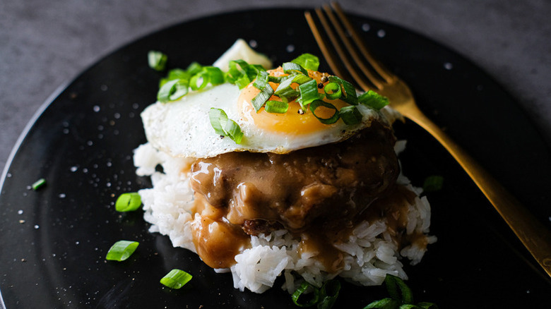 Plate of Hawaiian loco moco with rice, hamburger, and fried egg