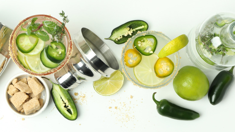 Concept of drink with jalapeno peppers, sugar, citrus.