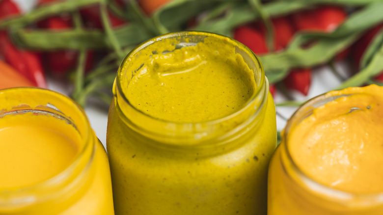 Three jars of huancaina sauce