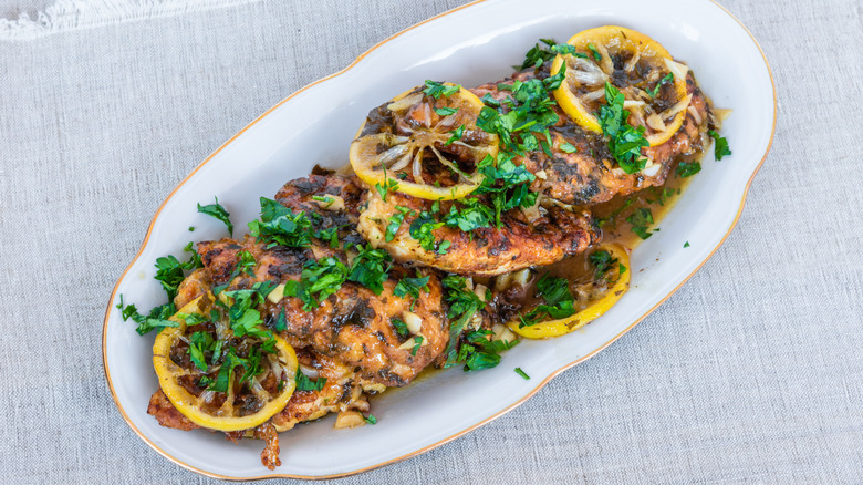 Platter of chicken Francese with parsley and lemon