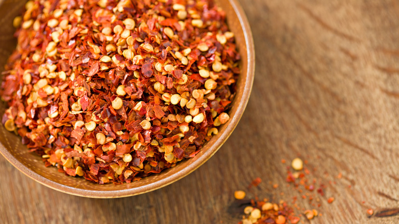 crushed red chile flakes in a wooden bowl