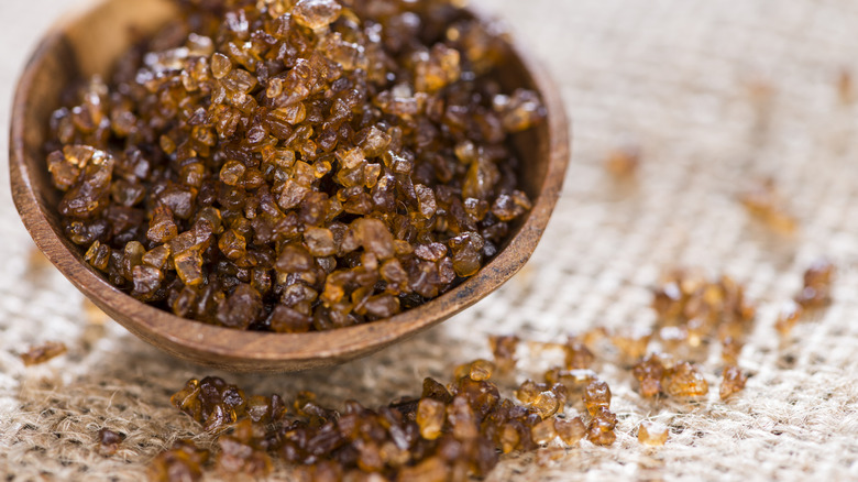coarse grain smoked salt in a rustic wooden bowl