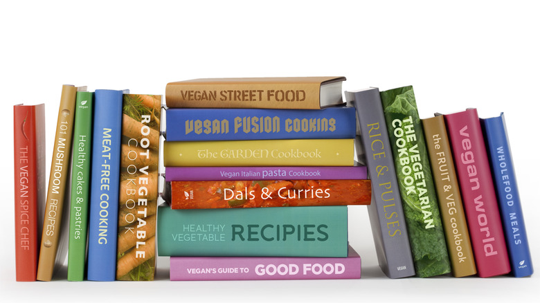 Several vegan and vegetarian recipe books against an isolated white background