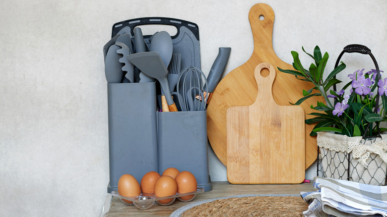 Kitchen countertop with wooden cutting boards and utensils