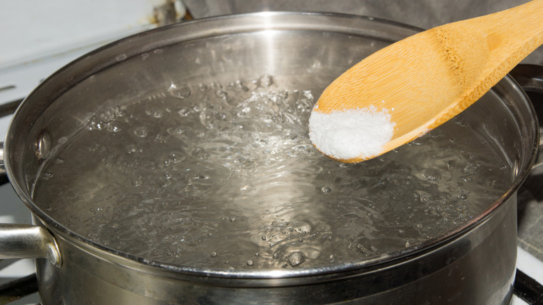 Adding salt to pot of pasta water